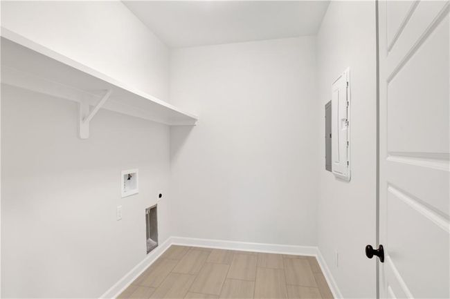 Clothes washing area featuring washer hookup, hookup for an electric dryer, laundry area, and baseboards | Image 24