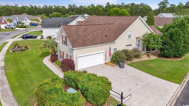 View of front of home with driveway, a residential view, a shingled roof, an attached garage, and a front lawn | Image 24