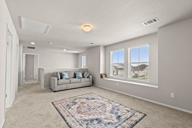 Living room with carpet flooring, attic access, baseboards, and a textured ceiling | Image 24