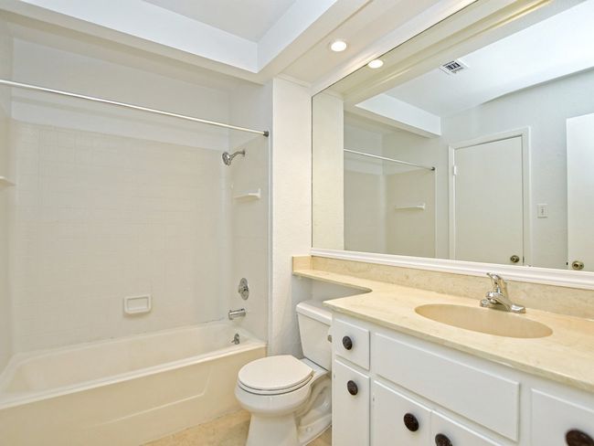 Bathroom with recessed lighting, shower combination, tile patterned floors, toilet, and vanity | Image 11