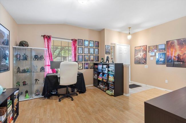 Office area with wood finished floors, vaulted ceiling, and baseboards | Image 29