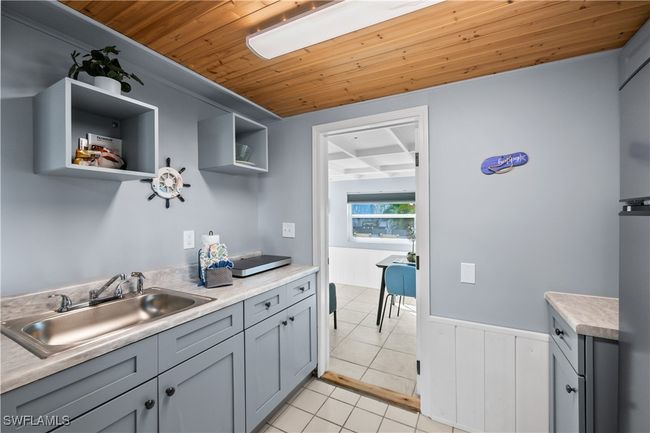 Kitchen with sink, gray cabinetry, wooden ceiling, and light tile patterned floors | Image 27