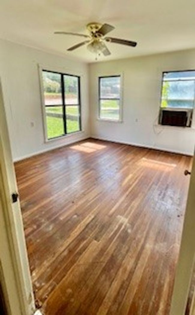 Spare room featuring wood finished floors and ceiling fan | Image 5