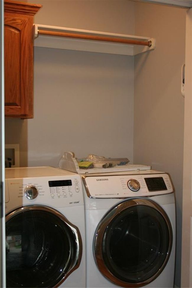 Washroom with washer and clothes dryer and cabinet space | Image 21