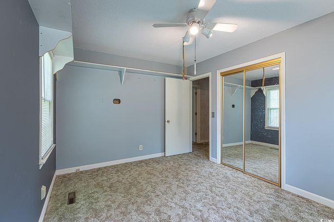Kitchen with white cabinets, a healthy amount of sunlight, light tile patterned floors, and ceiling fan | Image 13