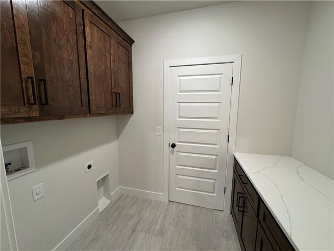 Washroom with cabinet space, hookup for an electric dryer, and hookup for a washing machine | Image 47
