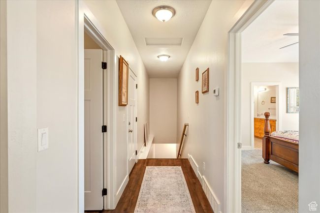 Corridor featuring dark wood finished floors, baseboards, and an upstairs landing | Image 37