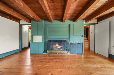 Living room with fireplace, ceiling beams and plank floors | Image 2