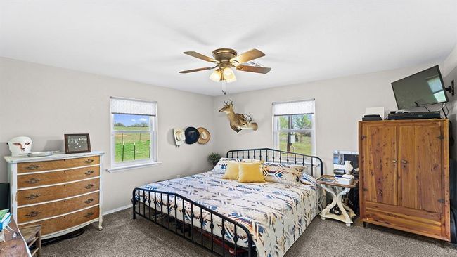 Bedroom featuring a ceiling fan and carpet flooring | Image 43