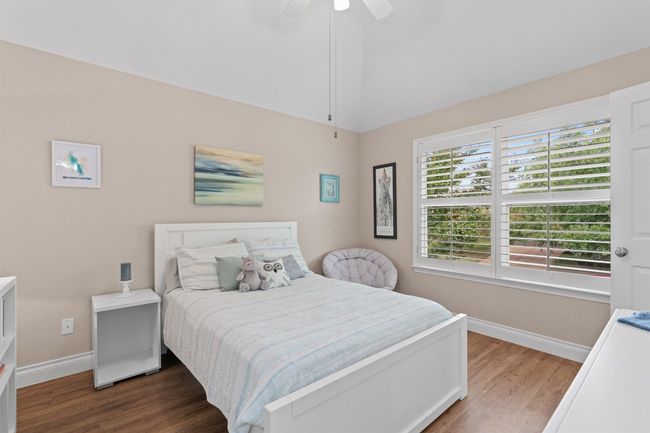 Bedroom featuring baseboards, wood finished floors, and a ceiling fan | Image 26