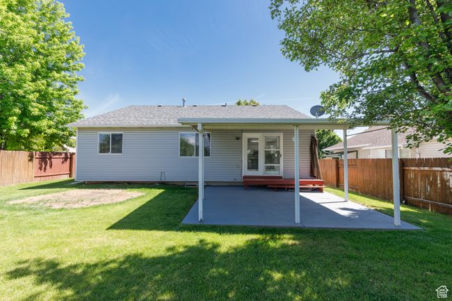 Rear view of house featuring a patio and roof with shingles | Image 24