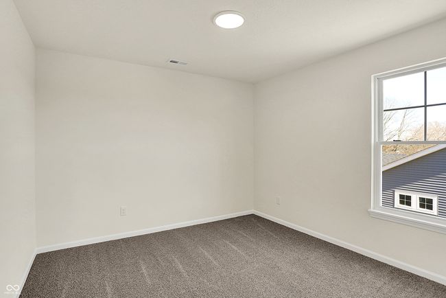 spare room with visible vents, baseboards, and dark carpet | Image 33
