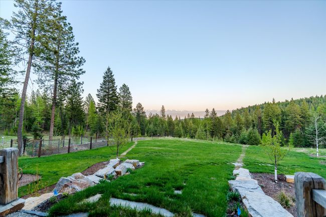 Landscaped yard with under ground sprinklers and a 22x50 fenced garden with organic soil | Image 44