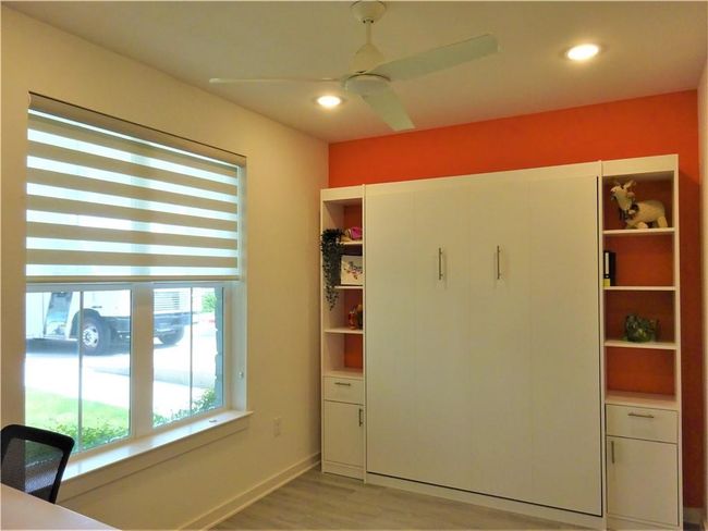 Unfurnished office featuring light wood finished floors, a ceiling fan, recessed lighting, and baseboards | Image 6