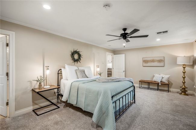 Bedroom featuring visible vents, crown molding, and carpet flooring | Image 24