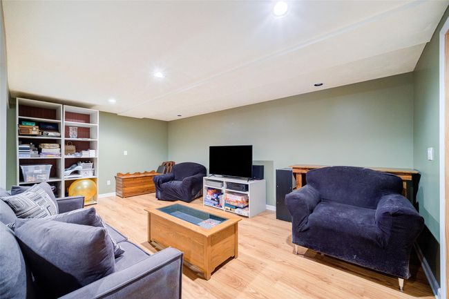 Partially finished basement with recessed lighting, light wood-type flooring, and baseboards. | Image 35