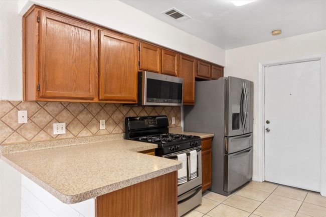 With ample storage and countertops space, this kitchen is as practical as it is stylish, ready for your culinary creations | Image 8