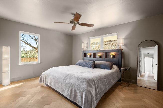 Bedroom with arched walkways, ceiling fan, and baseboards | Image 32