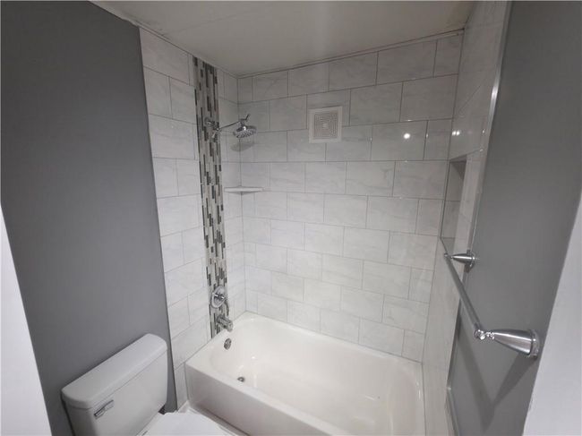 Bathroom with toilet and bathtub / shower combination | Image 17
