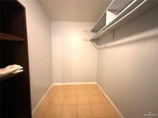 Spacious closet featuring light tile patterned floors | Image 14