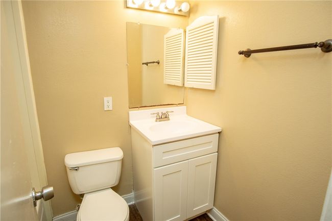 Bathroom featuring toilet and vanity | Image 8