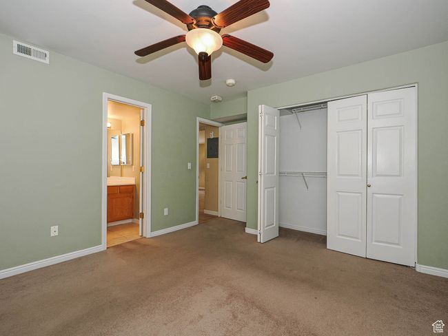 Unfurnished bedroom with a closet, carpet, baseboards, ensuite bath, and visible vents | Image 14