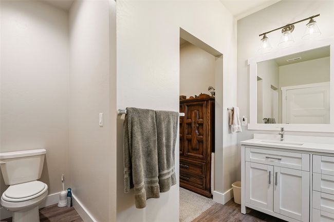 Bathroom featuring toilet, baseboards, vanity, and wood finished floors | Image 19