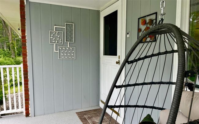 Property entrance featuring board and batten siding | Image 12