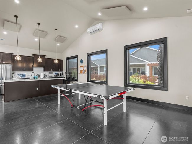 There's even a ping pong table that can be moved in and out. If you're cooking a giant feast and need more kitchen space, there's a full kitchen here too. | Image 28