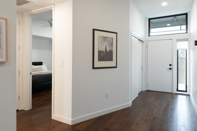 Foyer entrance featuring baseboards, visible vents, ceiling fan, and dark wood-style flooring | Image 13