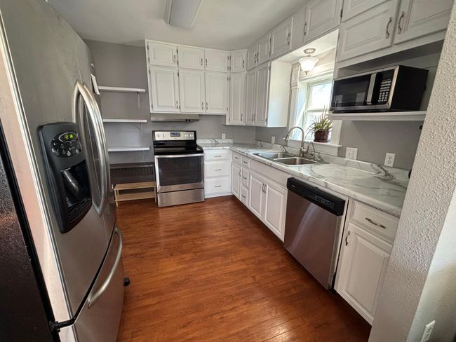 Kitchen with all stainless steel appliances and plenty of storage | Image 8