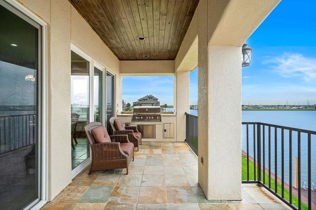 Located just off the kitchen, this covered terrace features a seamlessly connected outdoor grill—perfect for effortless entertaining and al fresco dining | Image 19
