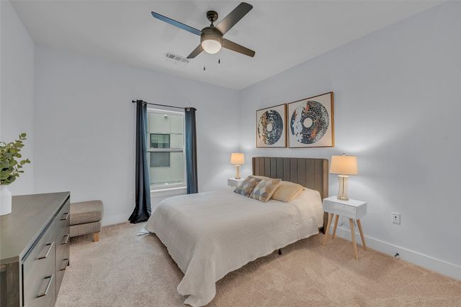 Bedroom featuring light colored carpet and a ceiling fan | Image 16