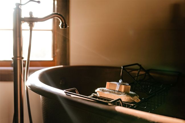 Main bathroom also features uniquely designed lighting, a vanity with antique hand forged branding iron legs, copper sinks and a copper soaking tub | Image 31