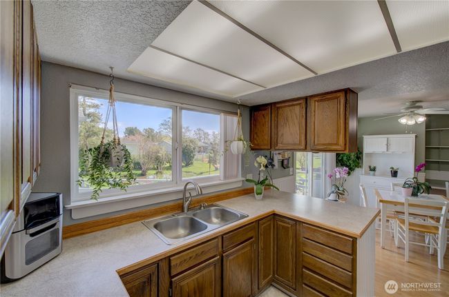 Looking through the kitchen to the dining room. | Image 16
