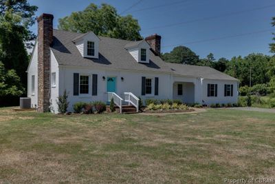 Cape cod house featuring central AC and a front lawn | Image 3