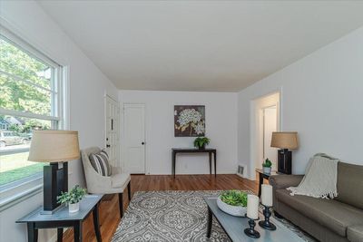 Living room has a coat closet for extra storage space. | Image 3