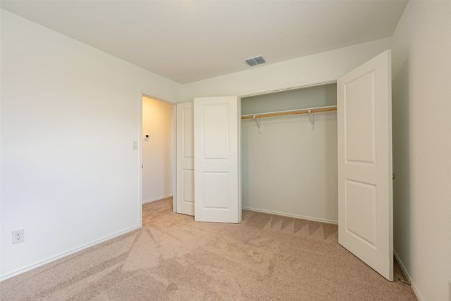 Unfurnished bedroom featuring light carpet, a closet, and baseboards | Image 16