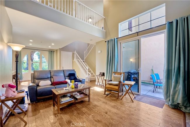 Tranquil living room opens out to private patio, upper windows allow a sunlit atmosphere while allowing privacy | Image 18