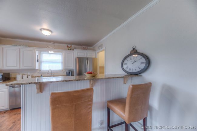 Extra seating at the bar to chat with friends while you cook. | Image 11