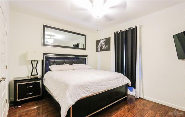 Bedroom with dark hardwood / wood-style flooring and ceiling fan | Image 24