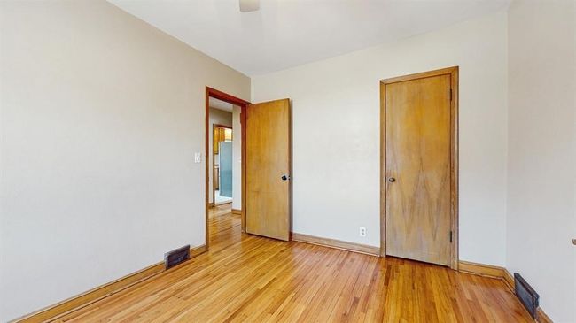 Main level bedroom #2. Refinished hardwood floors and fresh paint. | Image 8