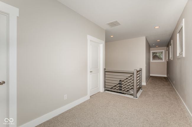 corridor featuring an upstairs landing, baseboards, carpet flooring, visible vents, and recessed lighting | Image 11