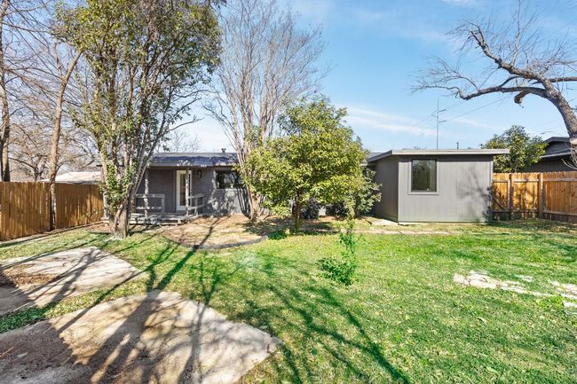Fenced backyard with an outdoor structure and a patio | Image 31
