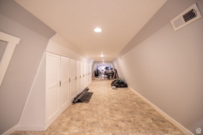 Exercise room featuring vaulted ceiling, recessed lighting, and stone finish flooring | Image 80