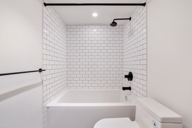 Full bathroom featuring toilet and washtub / shower combination | Image 30
