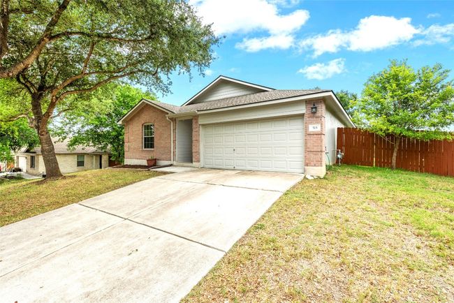 Ranch-style home featuring brick siding, an attached garage, concrete driveway, and a shingled roof | Image 29