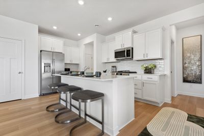 (Photo of decorated model, actual homes colors and finishes will vary) Open and naturally bright, the home's kitchen space is highly desirable | Image 2