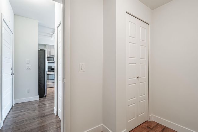 Hallway featuring dark wood-style floors and baseboards | Image 15