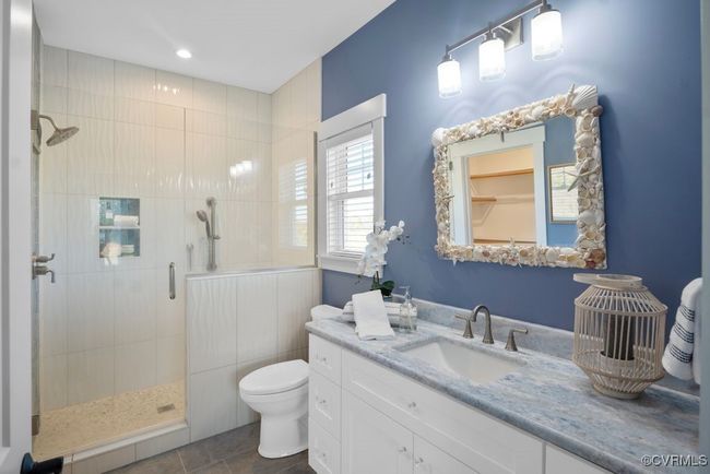 Bathroom featuring tile patterned floors, vanity, a tile shower, and toilet | Image 17